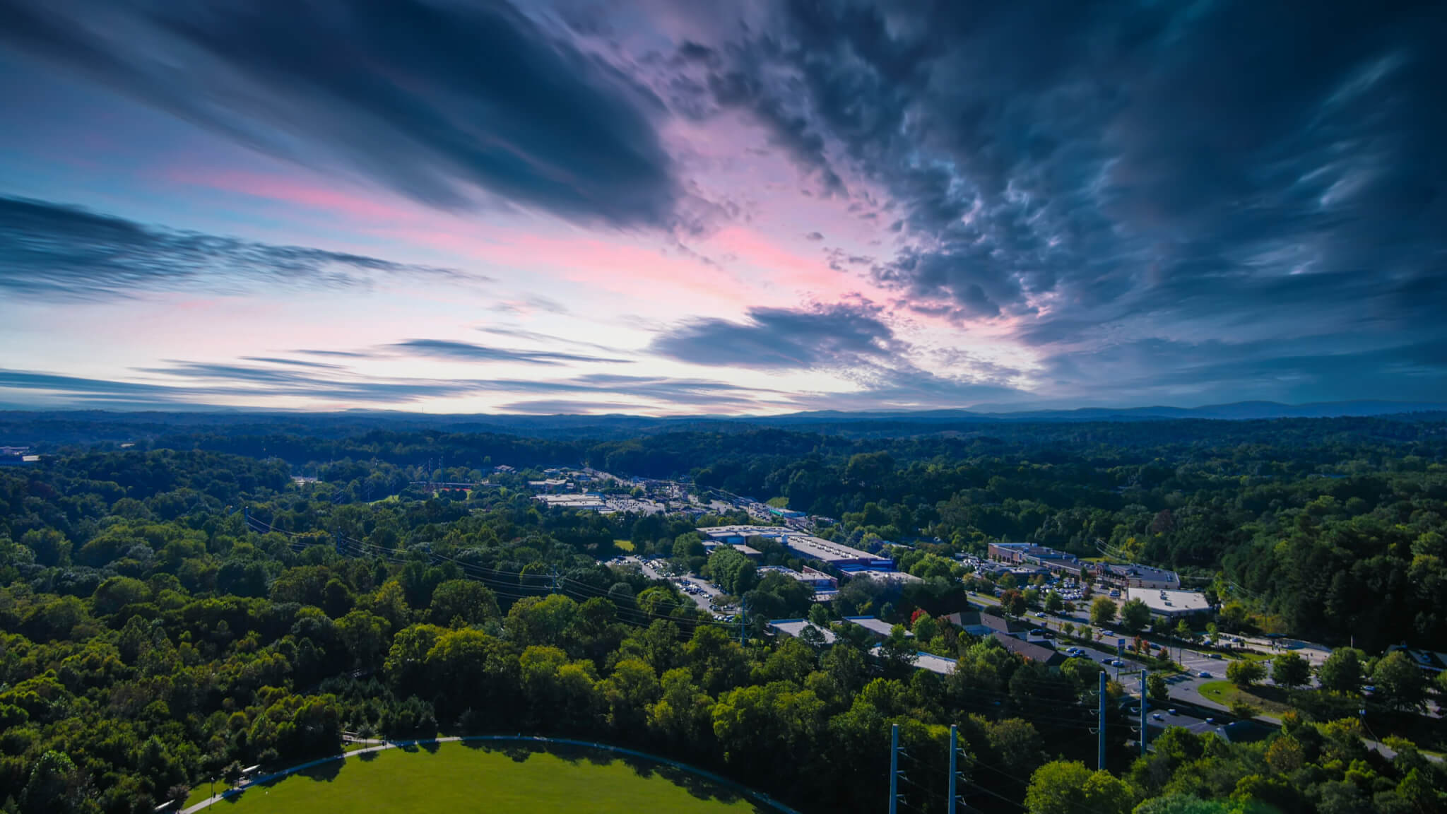 an aerial shot of the vast miles of lush green trees and grass w